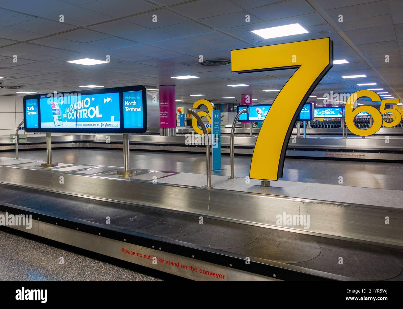 Colourful and modern airport baggage carousel showing no people or luggage Stock Photo