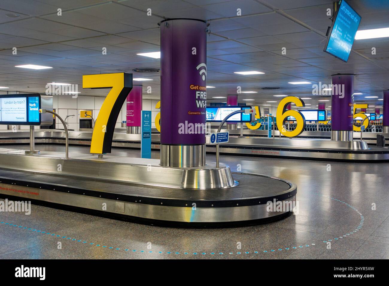 Colourful and modern airport baggage carousel showing no people or luggage Stock Photo