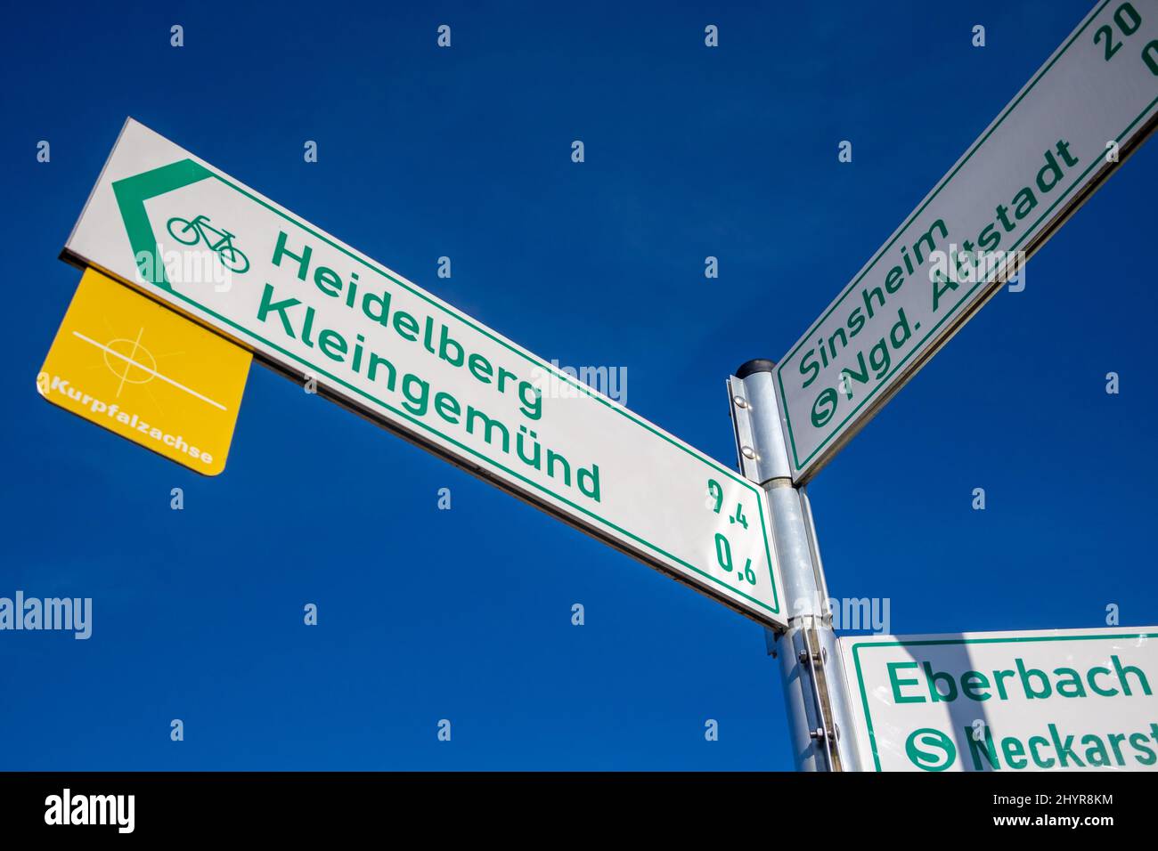 Signpost for bicycle tours with distance information which guides to 'Heidelberg', 'Kleingemuend', 'Sinsheim' and 'Eberbach' in Baden-Wuerttemberg, Ge Stock Photo