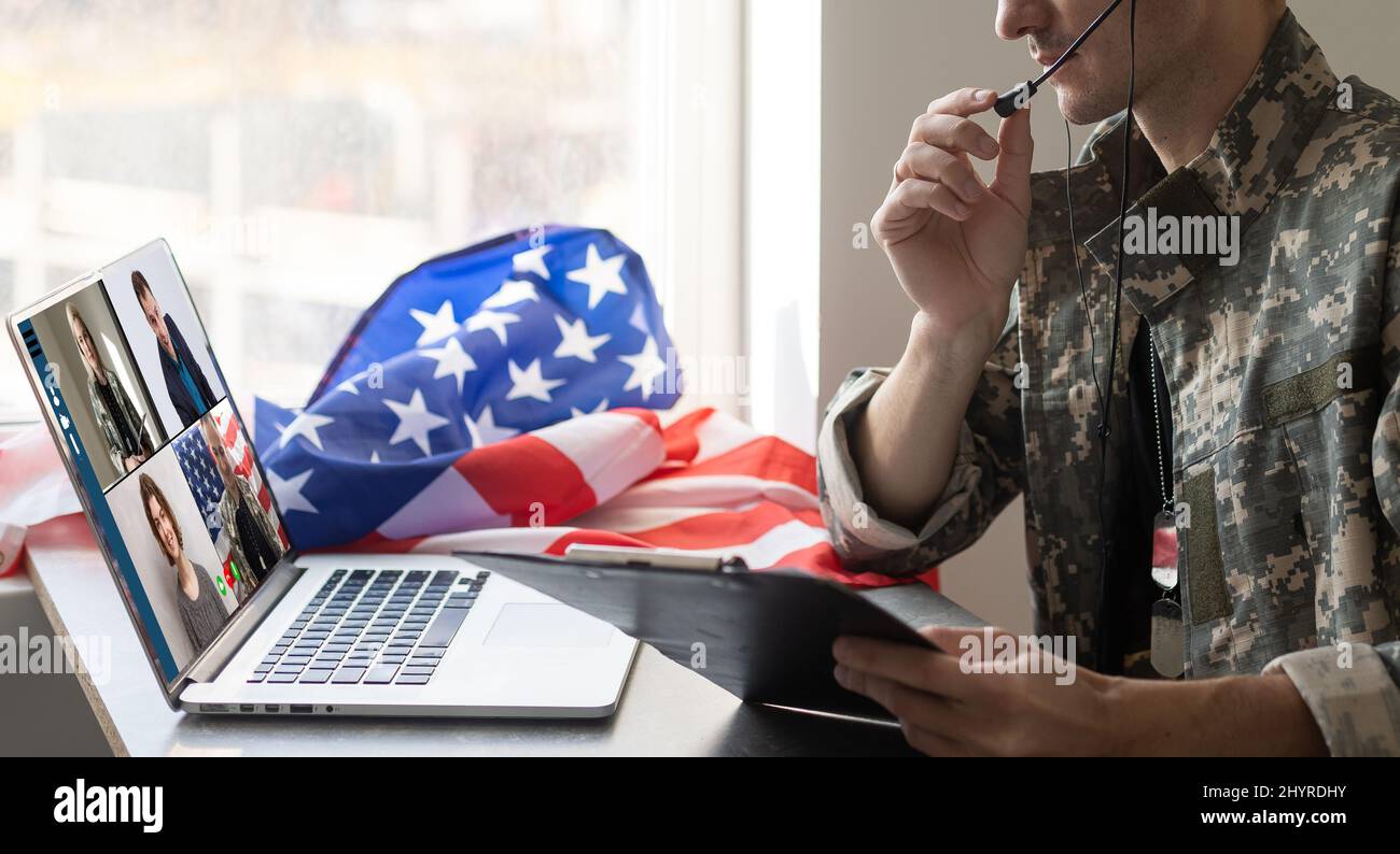 Mature male soldier using laptop in headquarters building for ...