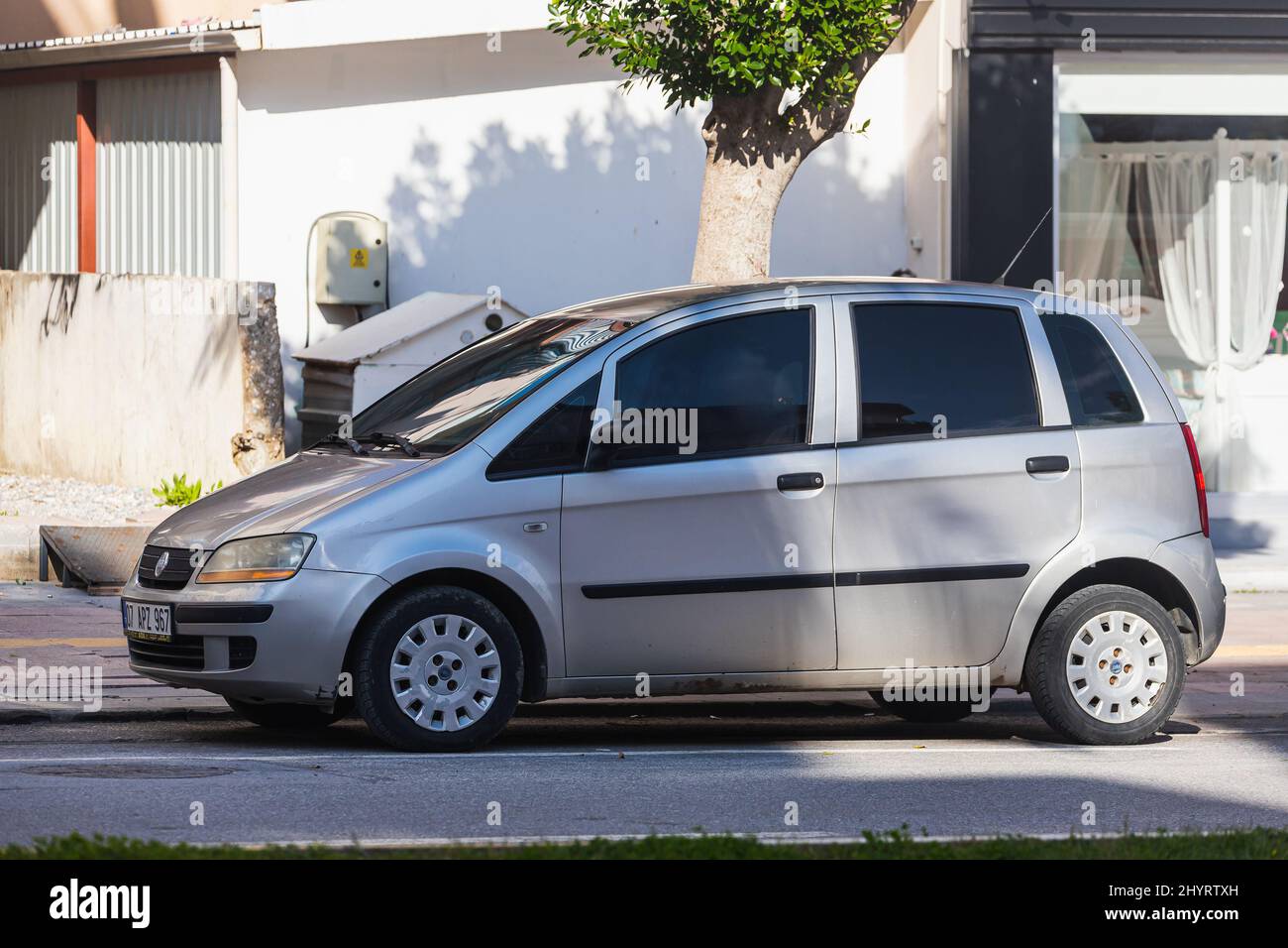 Side; Turkey – March 05 2022:   silver Fiat Idea  is parked  on the street on a warm day Stock Photo