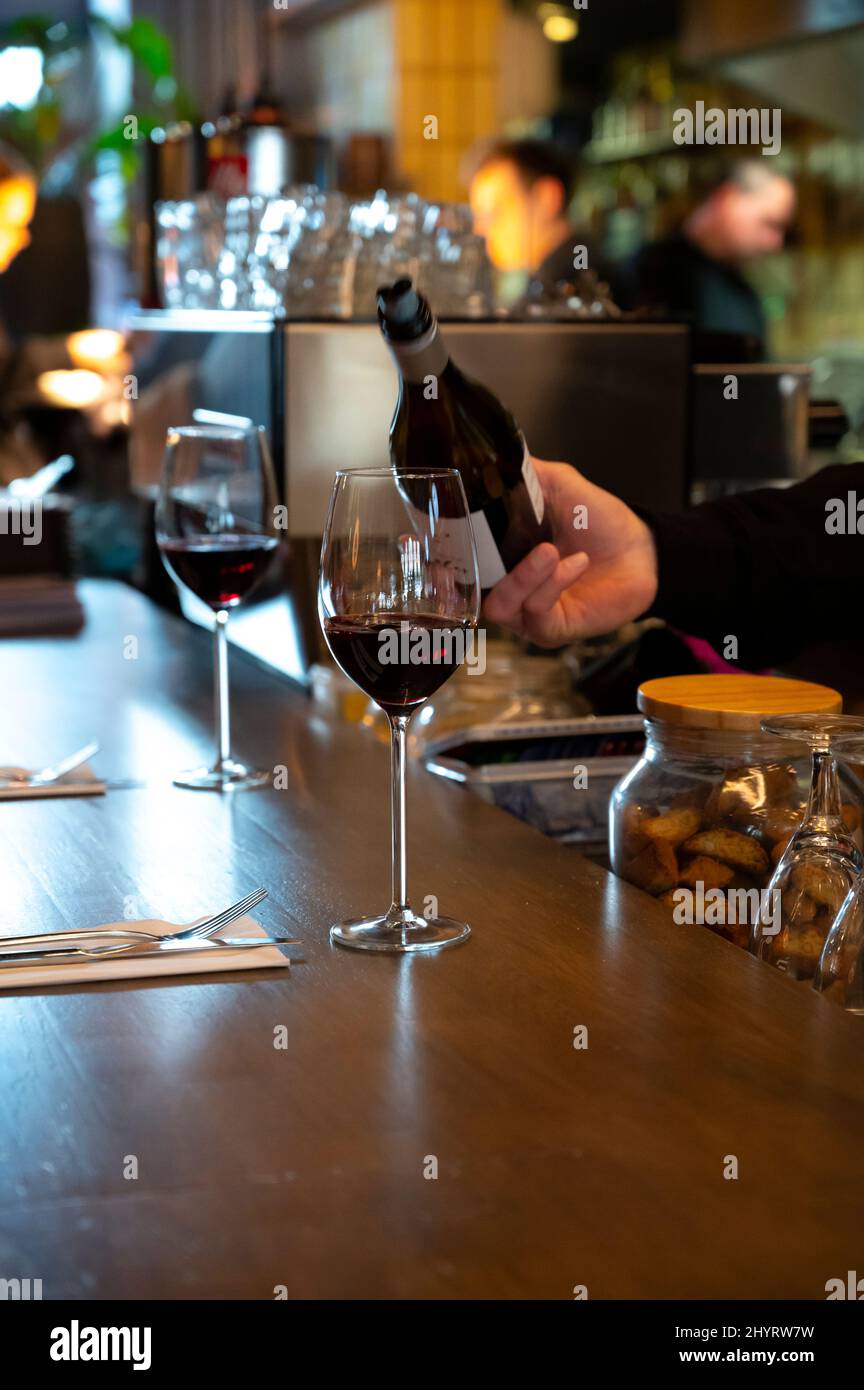 Pouring of dry Spanish tempranillo red wine in glass in Spanish bogeda