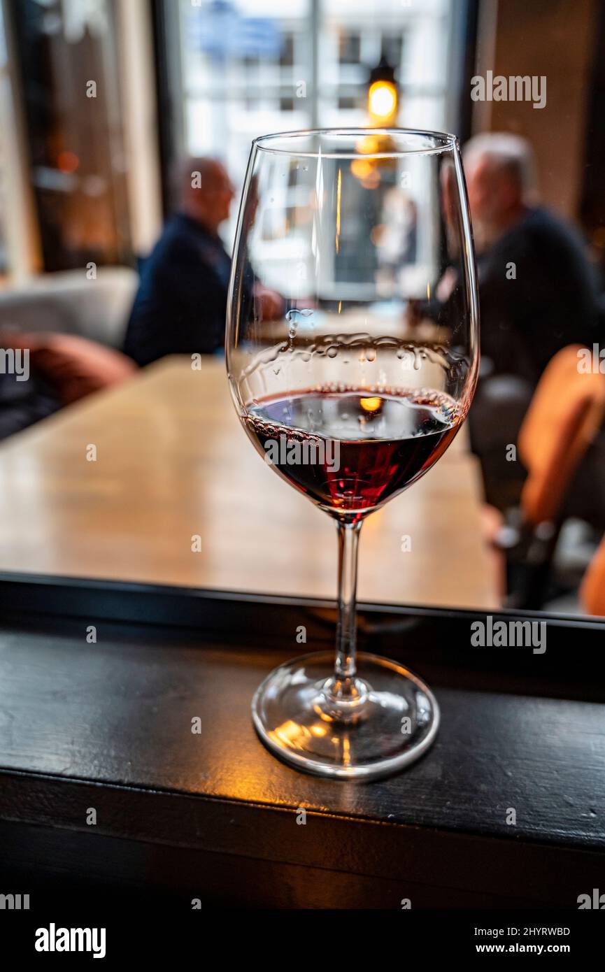 Glass of dry French merlot red wine from Bordeaux, France, close up