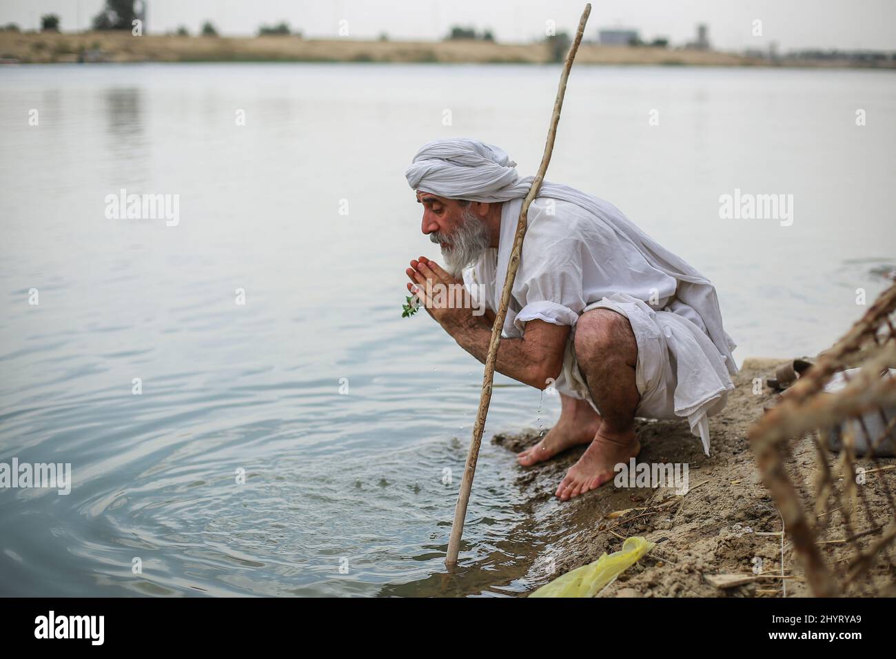 Baghdad, Iraq. 15th Mar, 2022. A member of the Sabaean-Mandaean community performs a purification ritual on the banks of the Tigris River during Eid Al-Khalqeh (Feast of Creation). Credit: Ameer Al Mohammedaw/dpa/Alamy Live News Stock Photo