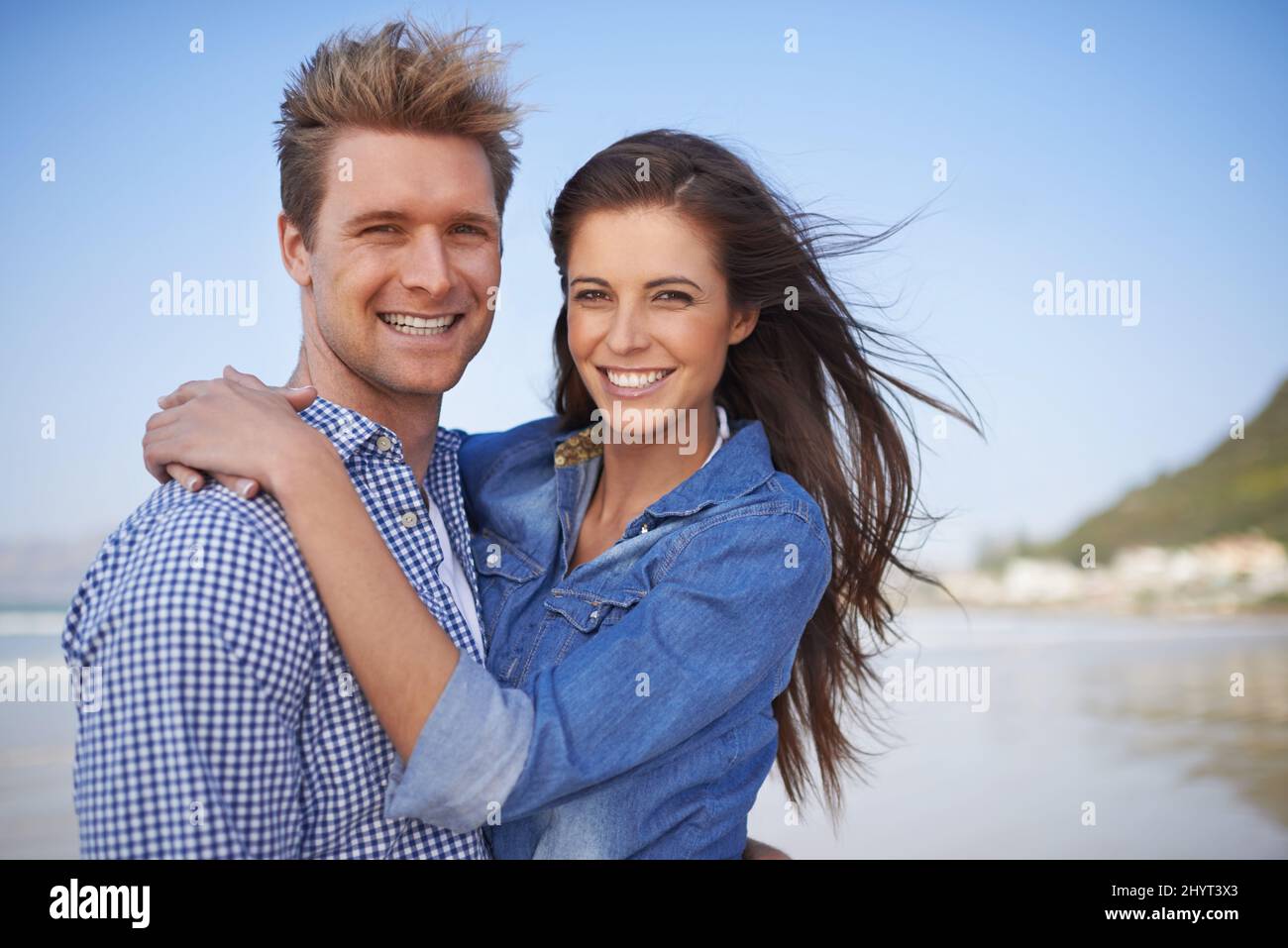Our love is forever. A young couple embracing happily on the beach. Stock Photo