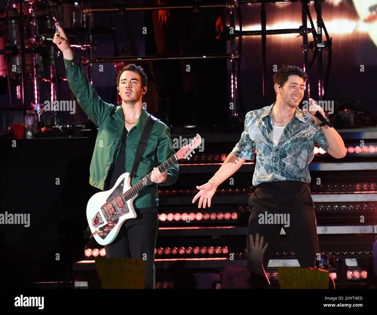 Kevin Jonas and Nick Jonas onstage at the Nashville tour stop of their