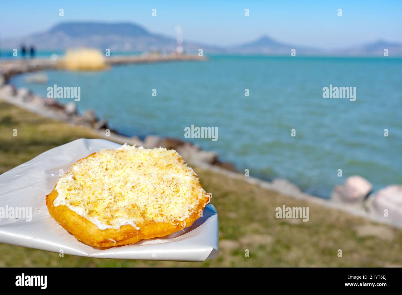 typical hungarian lake Balaton food langos with lake background in Fonyod Stock Photo