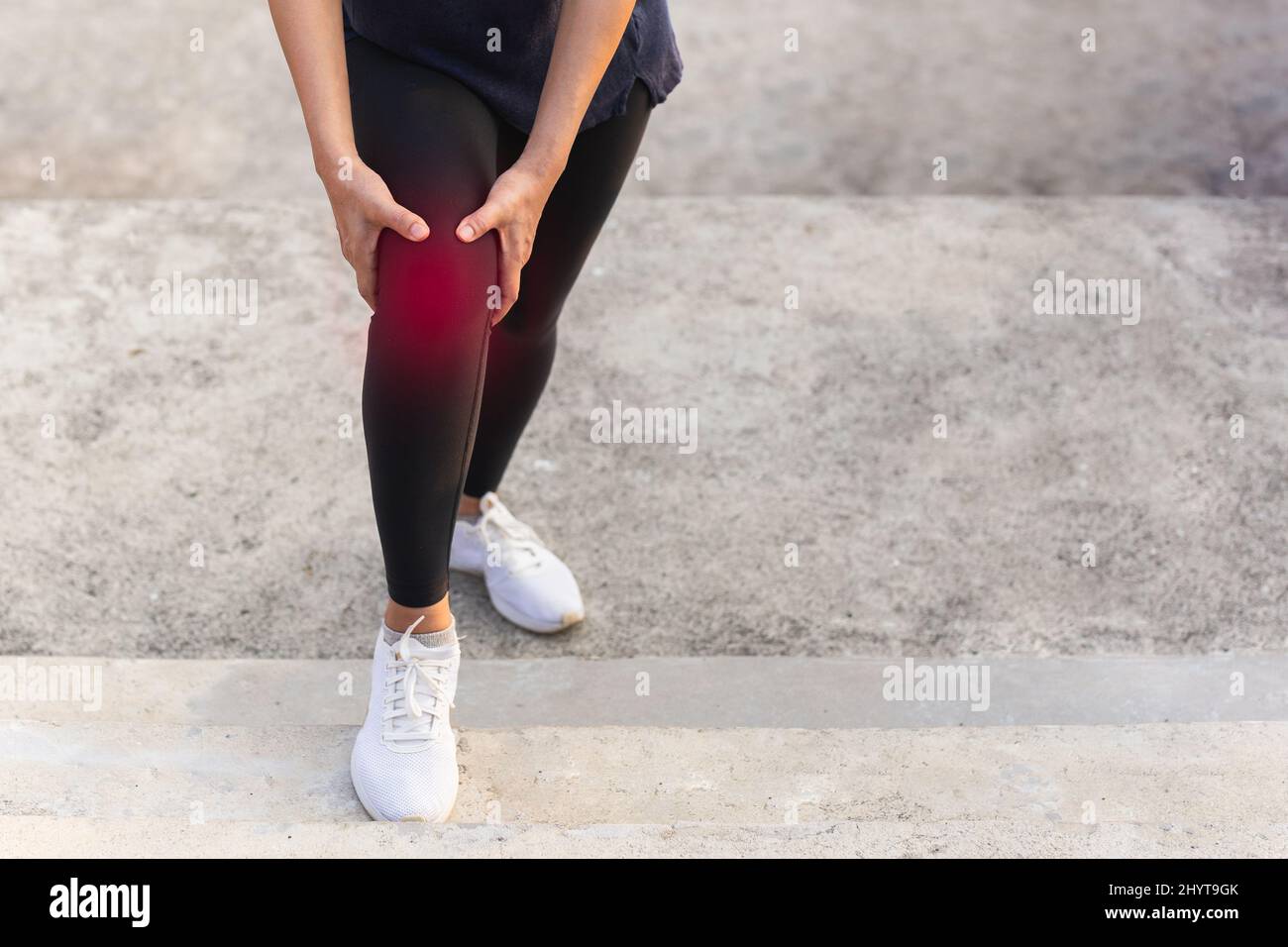 Women got knee pain while exercise walking up the stairs Stock Photo