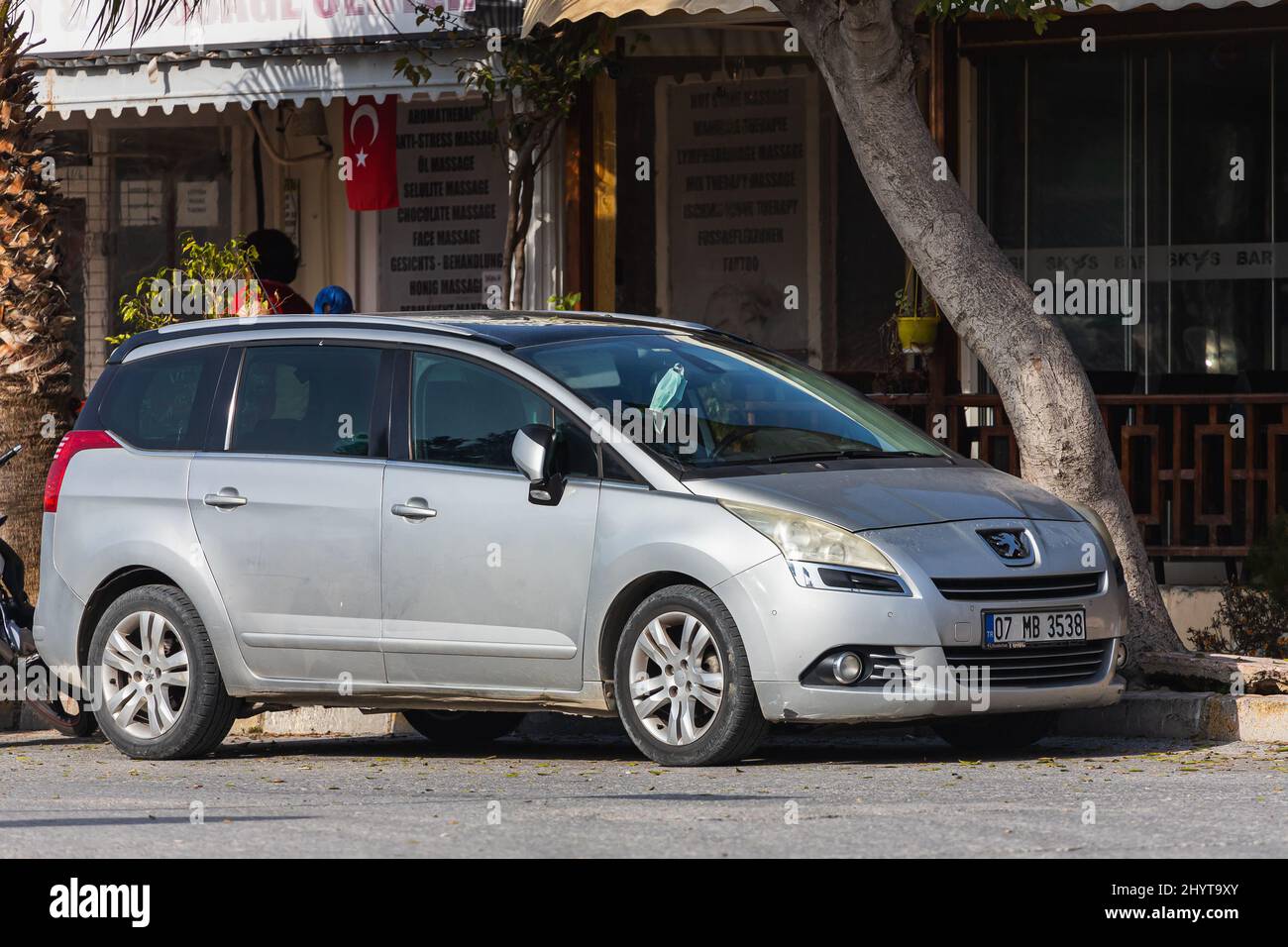 Side, Turkey – February 06 2022: silver  Peugeot 5008  is parked  on the street on a warm  day against the backdrop of a street, building Stock Photo