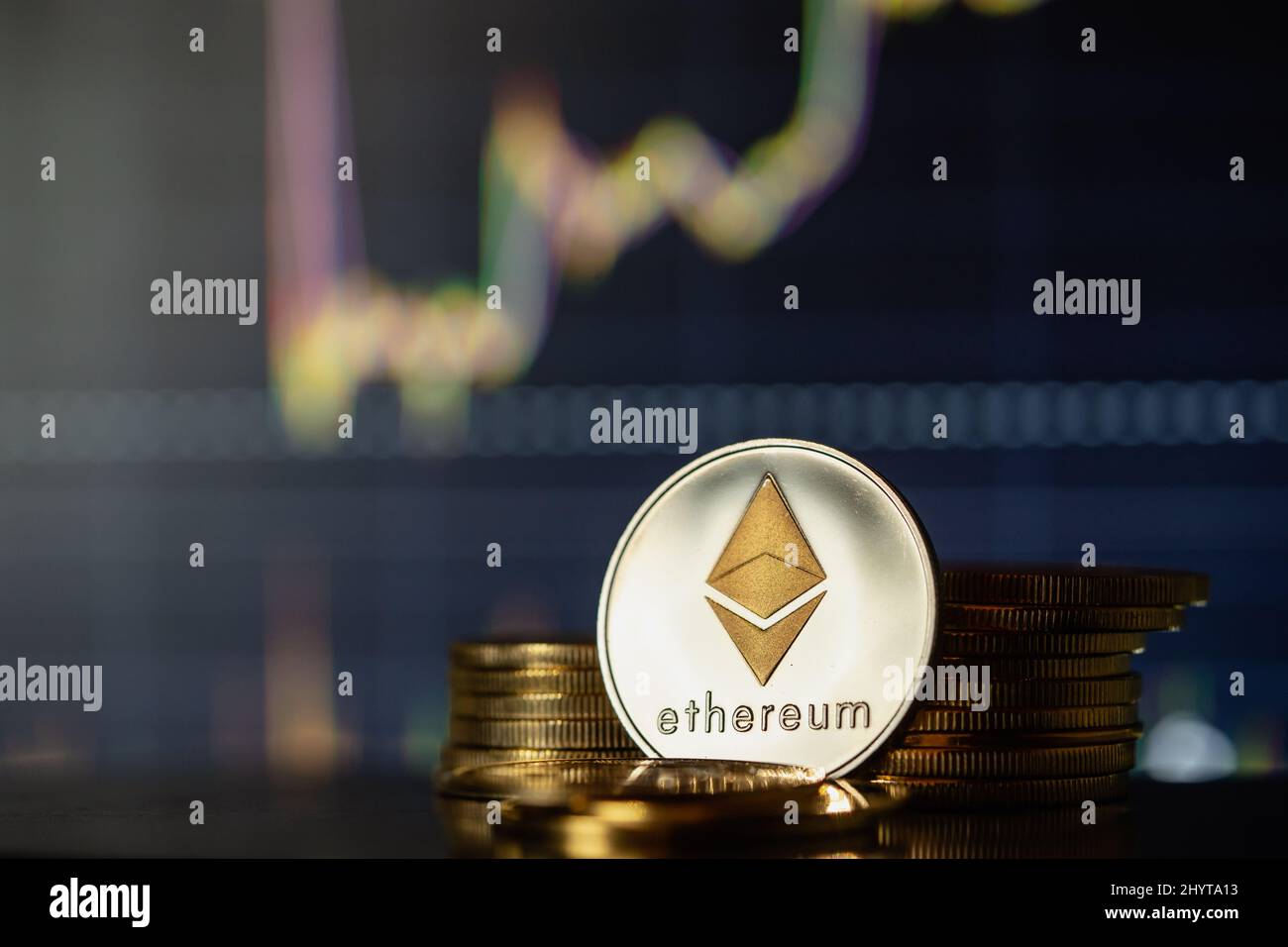 Stack or heap of silver Ethereum cryptocurrency with candle stick graph