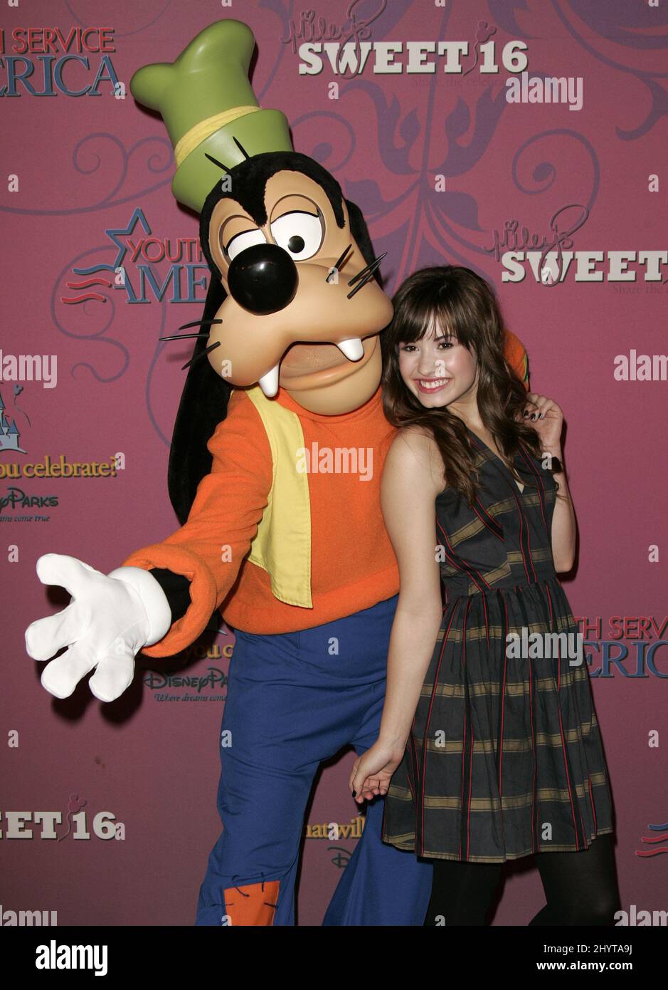 Demi Lovato and Goofy attend Miley Cyrus' Sweet 16 Birthday Bash, held at Disneyland. Stock Photo
