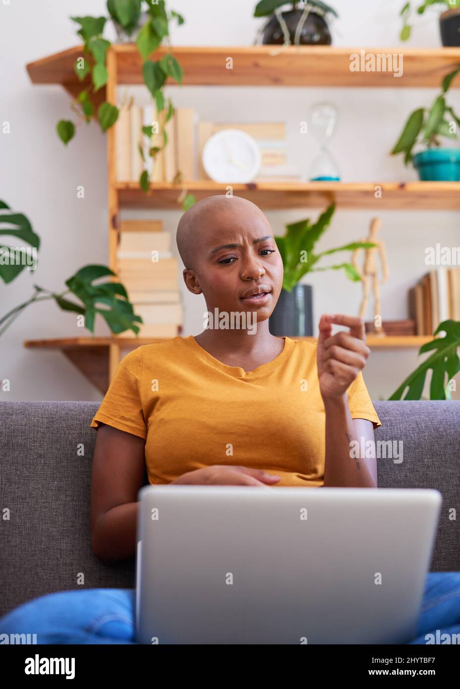 A young woman makes a point during a teleconference call from home Stock Photo
