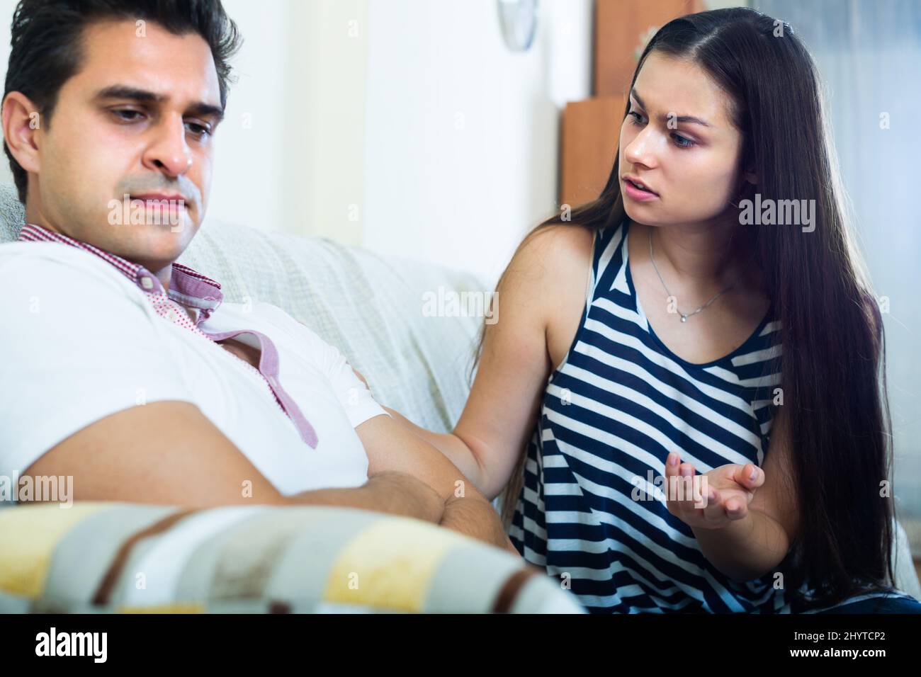 Young couple during indoor quarrel . Stock Photo