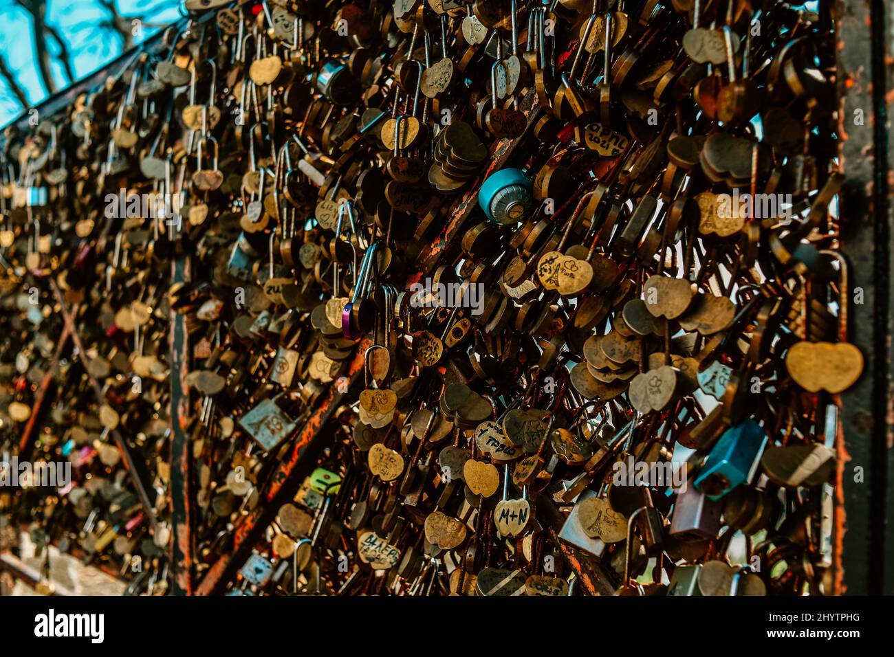 A lot of locks with the names of lovers on the bridge in Paris on montmarte near the Basilica church. Stock Photo