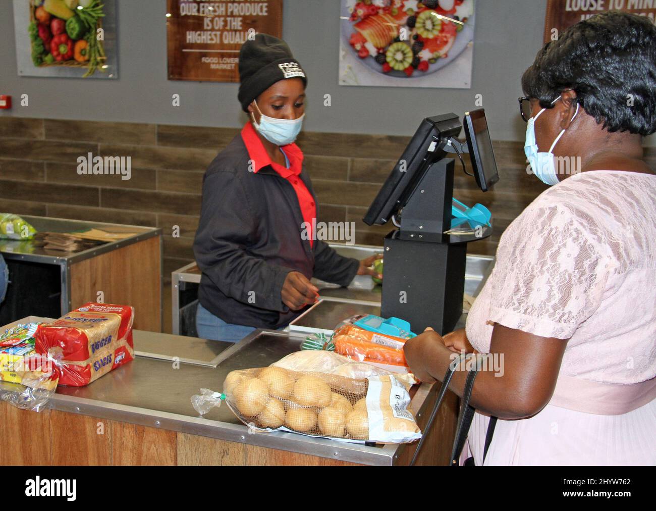 Windhoek, Namibia. 15th Mar, 2022. A woman pays for the goods she purchased in a supermarket in Windhoek, Namibia, March 15, 2022. Namibia's annual inflation rate in February 2022 continued on an upward trend, increasing by 4.5 per cent compared to 2.7 per cent recorded in February 2021, the country's statistics agency (NSA) said Tuesday. Credit: Musa C Kaseke/Xinhua/Alamy Live News Stock Photo