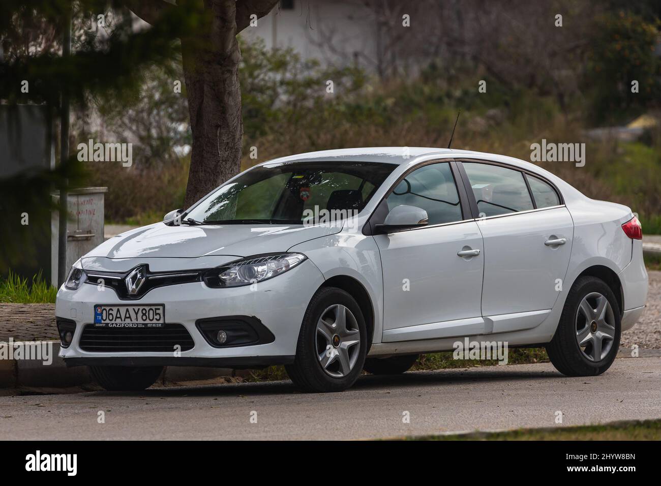 Side, Turkey – February 20 2022:  swhite Renault Fluence   is parked  on the street on a warm summer day against the backdrop of a street, park Stock Photo