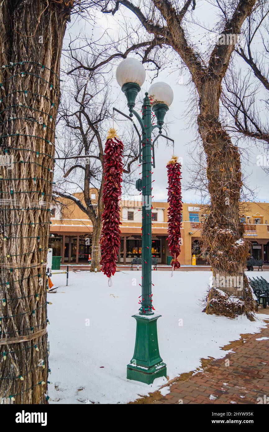 long red pepper ristras laced with snow on a winter morning at the historic Plaza in Santa Fe, New Mexico Stock Photo