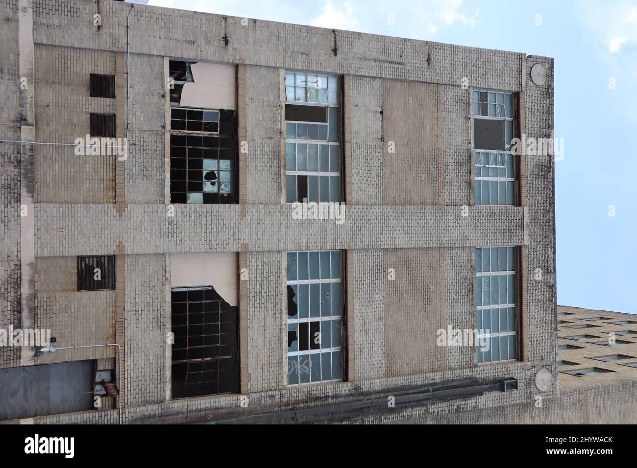Old building that has been dilapidated, with broken glass windows in ...