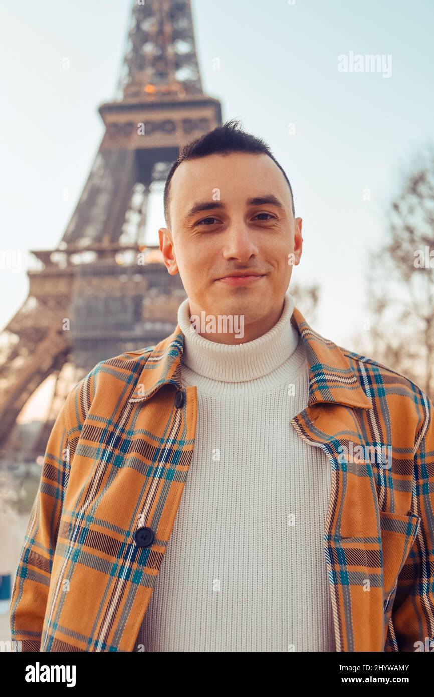 Guy tourist on the background of the Eiffel Tower posing. Male tourist