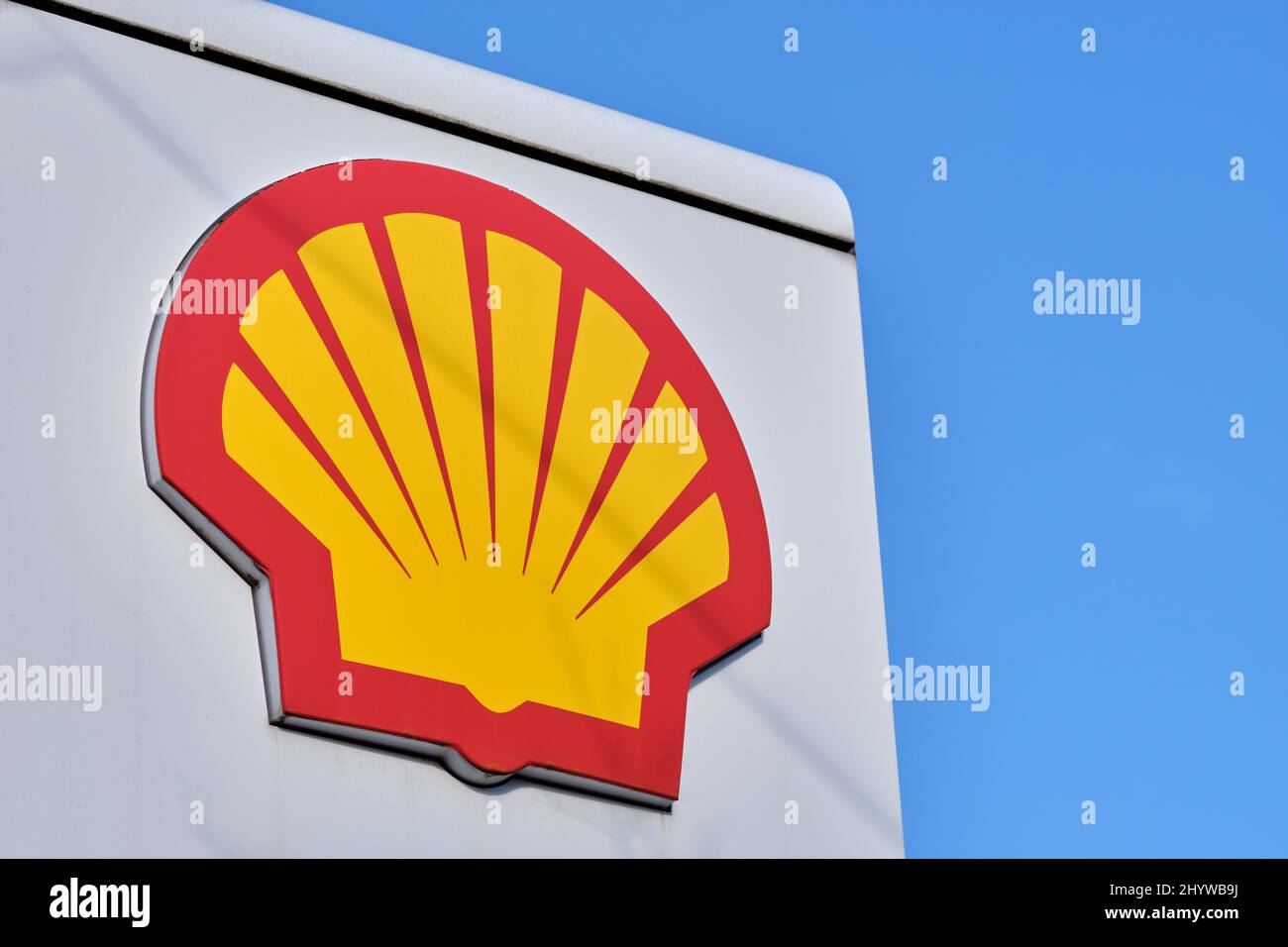 Nuremberg, Germany - March 14, 2022: Close - up of the logo of the Shell oil and gas company at a gas station against blue sky. Stock Photo
