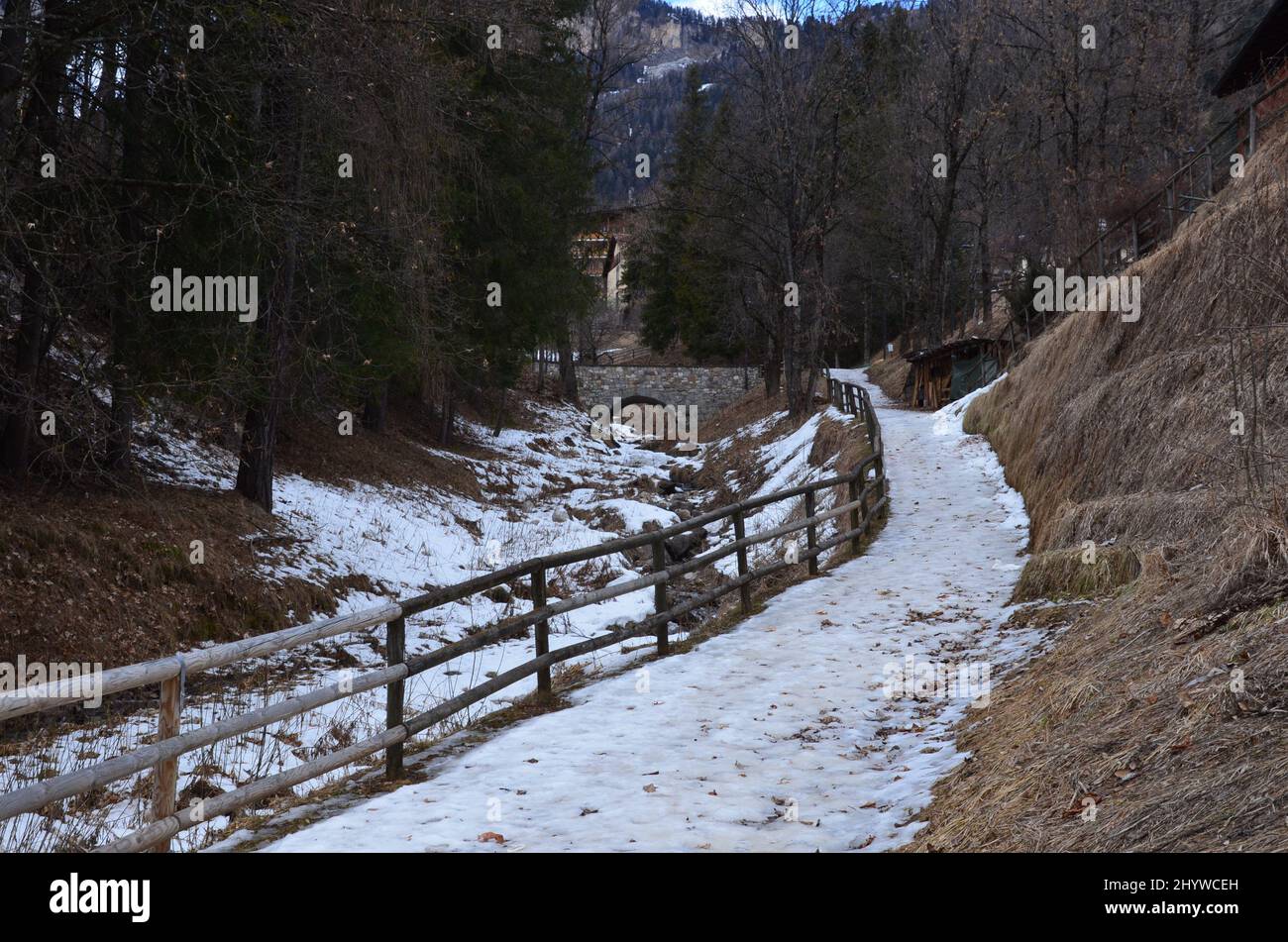 Photos of the snowcapped Dolomites during a winter trip and the small villages in the mountain valleys on a sunny, cold day Stock Photo