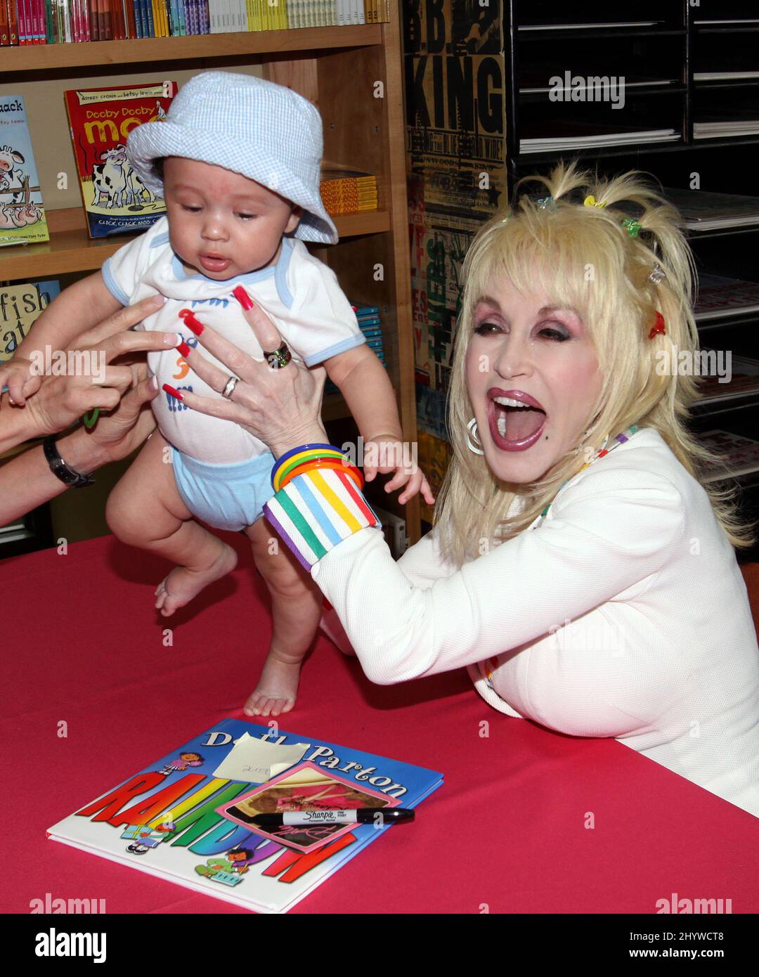 Dolly Parton signs copies of her children's book "I Am a Rainbow" at the Country Music Hall of