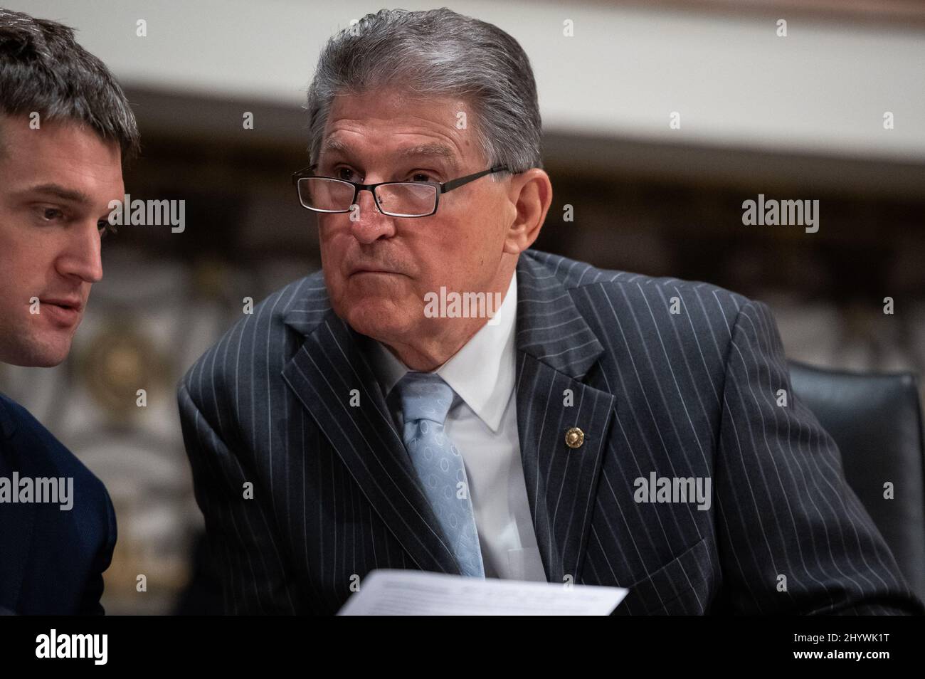 Washington, USA. 15th Mar, 2022. Senator Joe Manchin (D-W.V.) speaks with an aide during a Senate Armed Services committee hearing on Central Command and Africa Command, at the U.S. Capitol, in Washington, DC, on Tuesday, March 15, 2022. President Joe Biden will sign a major budget bill today after it passed through Congress last week, as three European Prime Ministers visit Kyiv amid the ongoing Russian attack on Ukraine. (Graeme Sloan/Sipa USA) Credit: Sipa USA/Alamy Live News Stock Photo