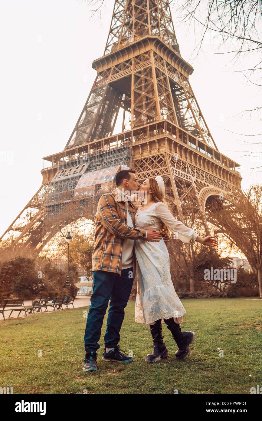 A couple kissing in front of the Eiffel Tower in Paris. Romantic trip,  honeymoon in Europe. France city of love Stock Photo - Alamy