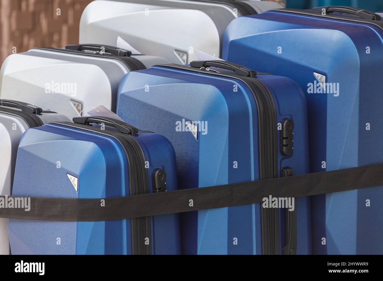 Bright colorful rows of suitcases with extended handles and different