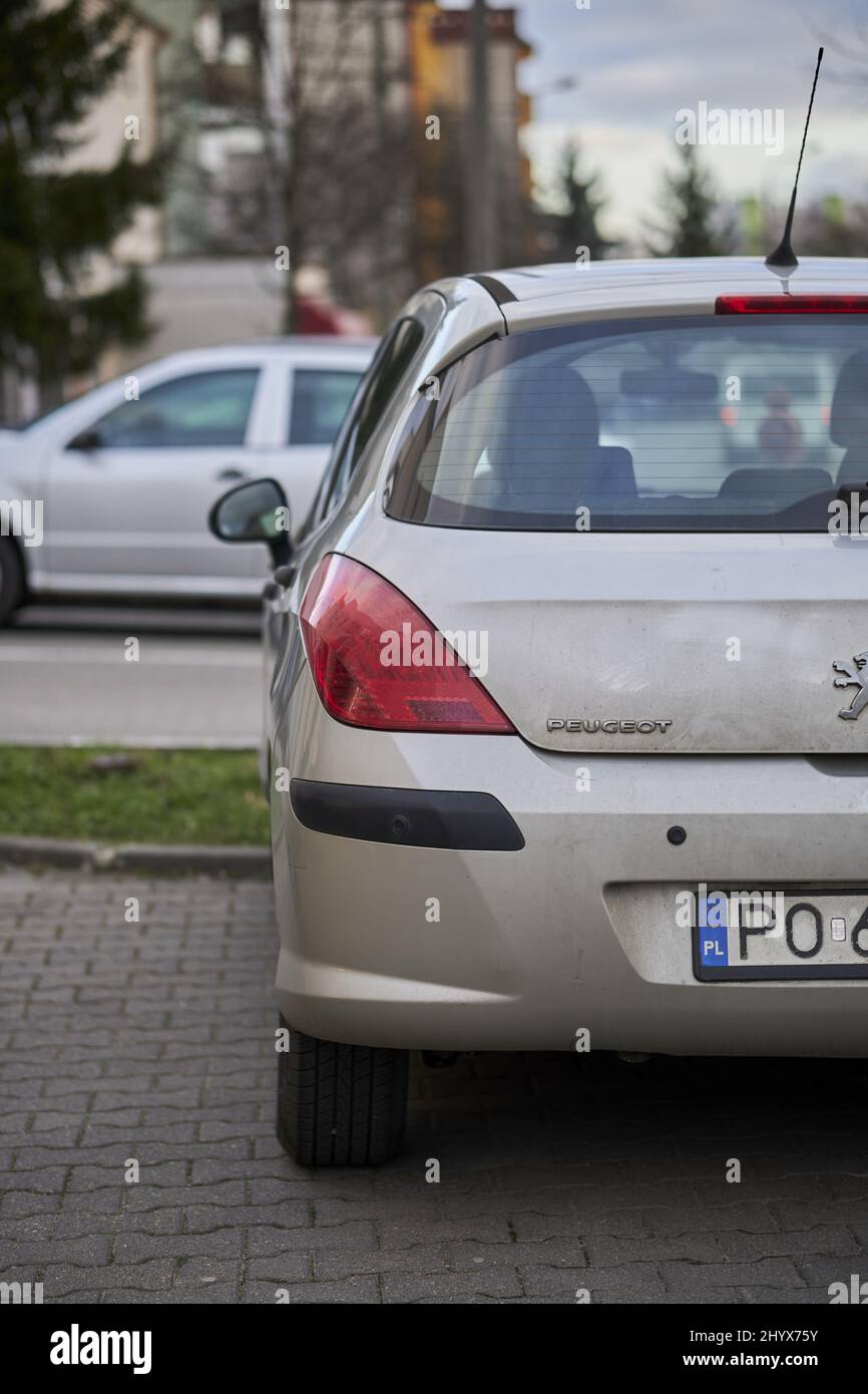 Vertical shot of a parked Peugeot car in the Stare Zegrze district in Poland Stock Photo