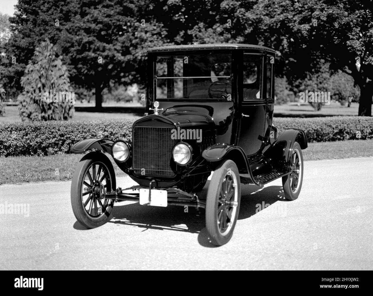Black and White image of 1923 Ford Model T Coupe on pavement. Stock Photo