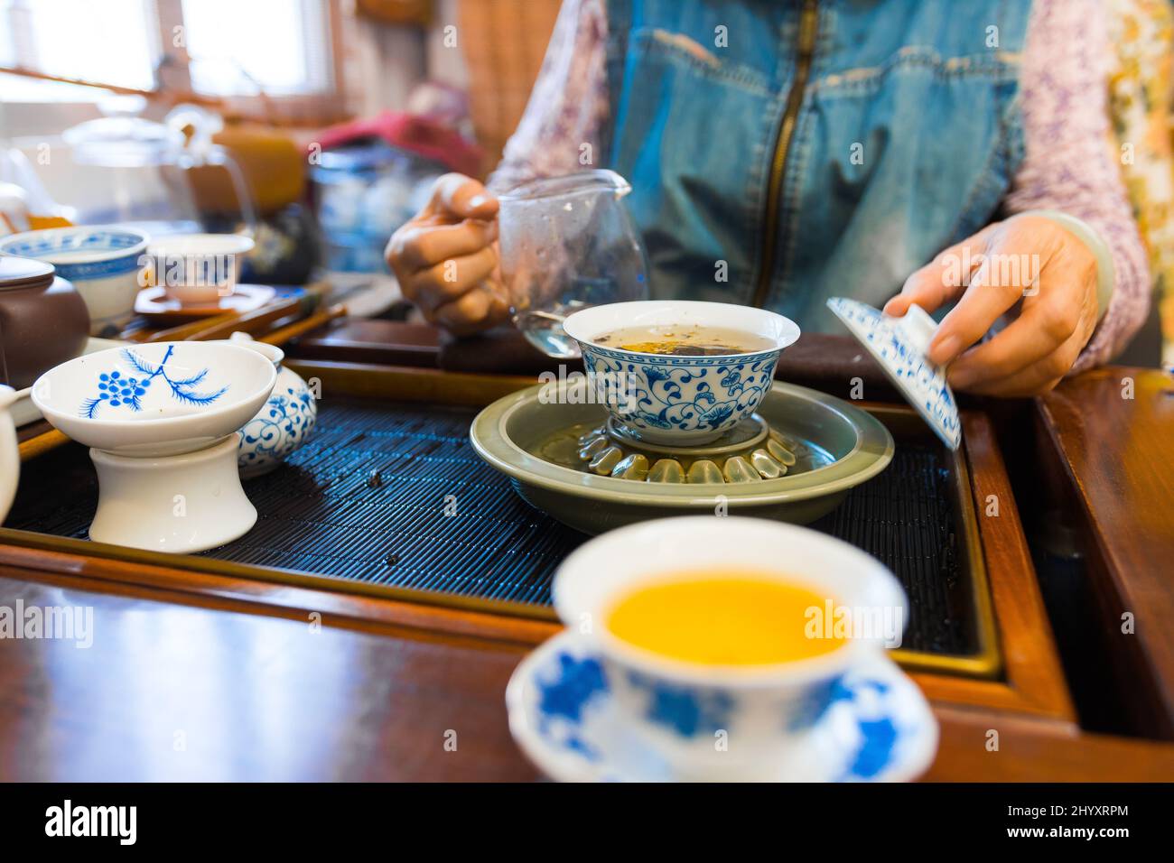 Gong Fu Cha brewing using a porcelain gaiwan and a glass justice