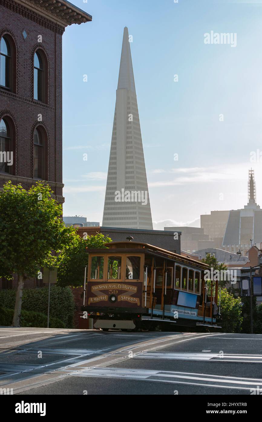 Cable car in the street and Transamerica building, San Francisco, California Stock Photo