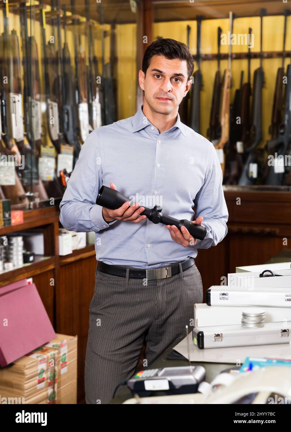 Salesman offering accessories for hunt Stock Photo Alamy