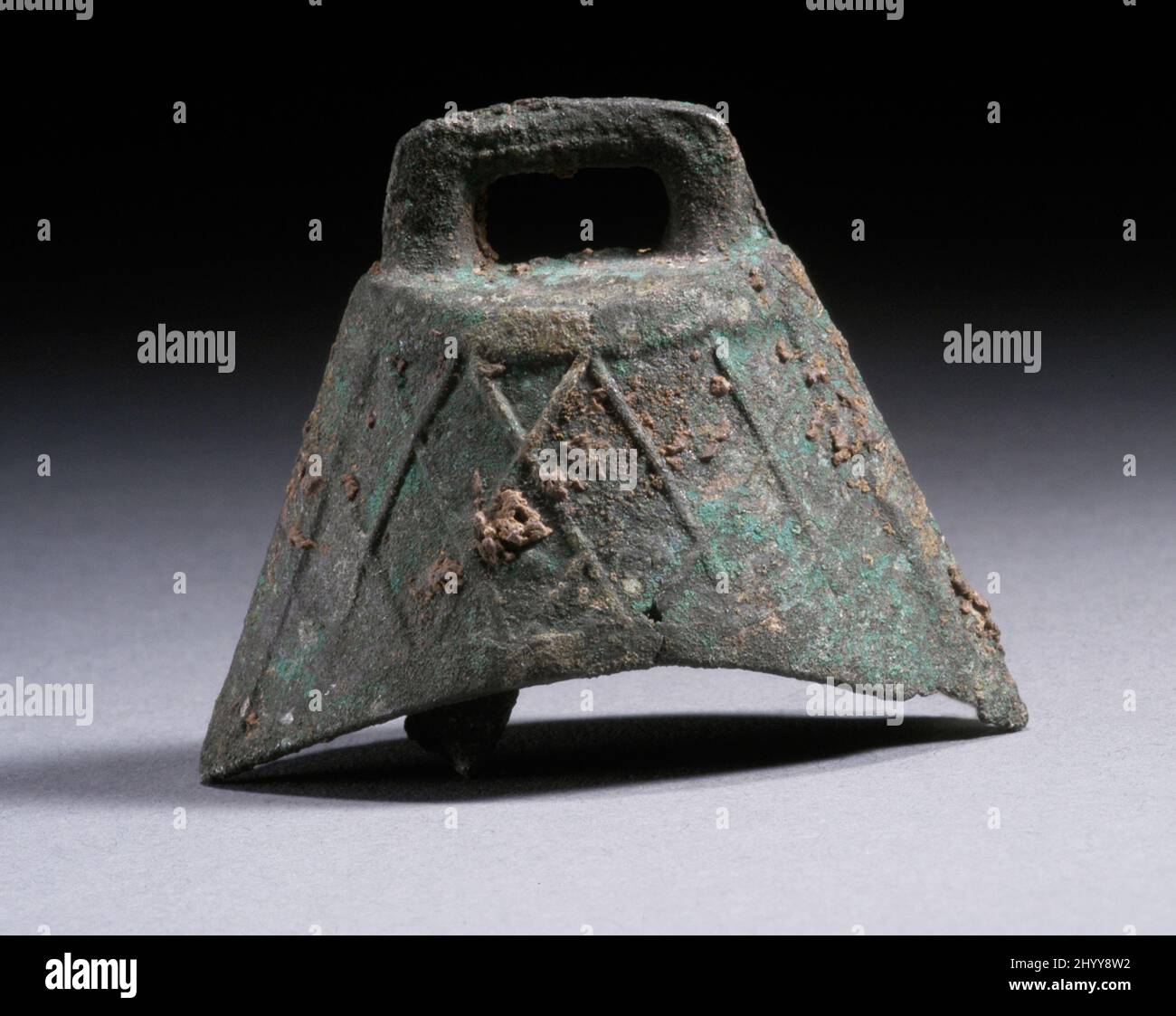 Dog Bell with Lozenges. China, Late Shang dynasty, Anyang phase, about 1300-1050 B.C.. Tools and Equipment; musical instruments. Cast bronze Stock Photo