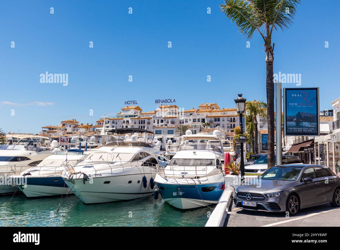 Shopping center in Puerto Banus, a marina near Marbella, Andalusia. Several  street vendors expect to sell your goods Stock Photo - Alamy