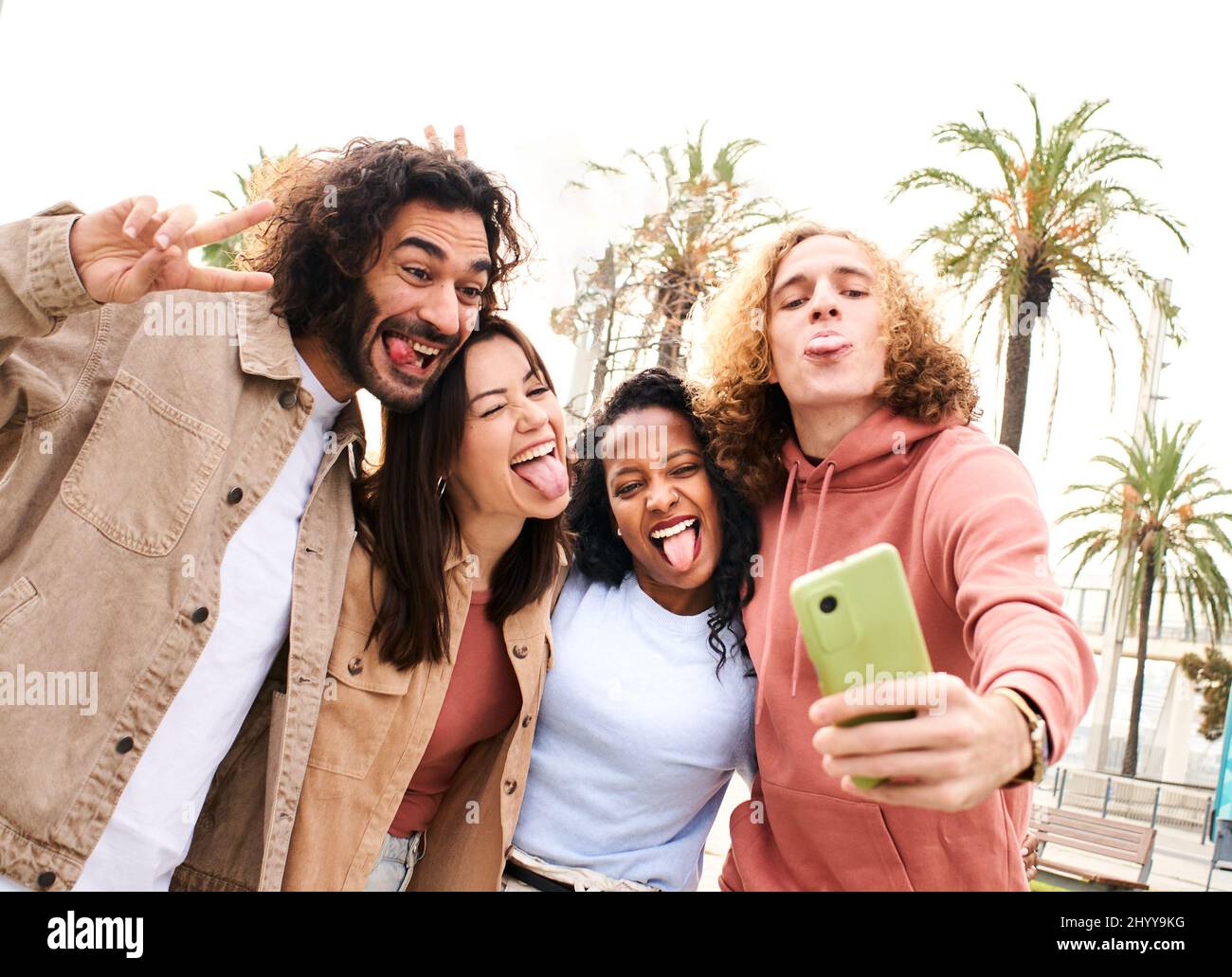 Group of cheerful young couples taking selfie portrait fool around. Happy people having fun. Concept of community, youth lifestyle and friendship Stock Photo