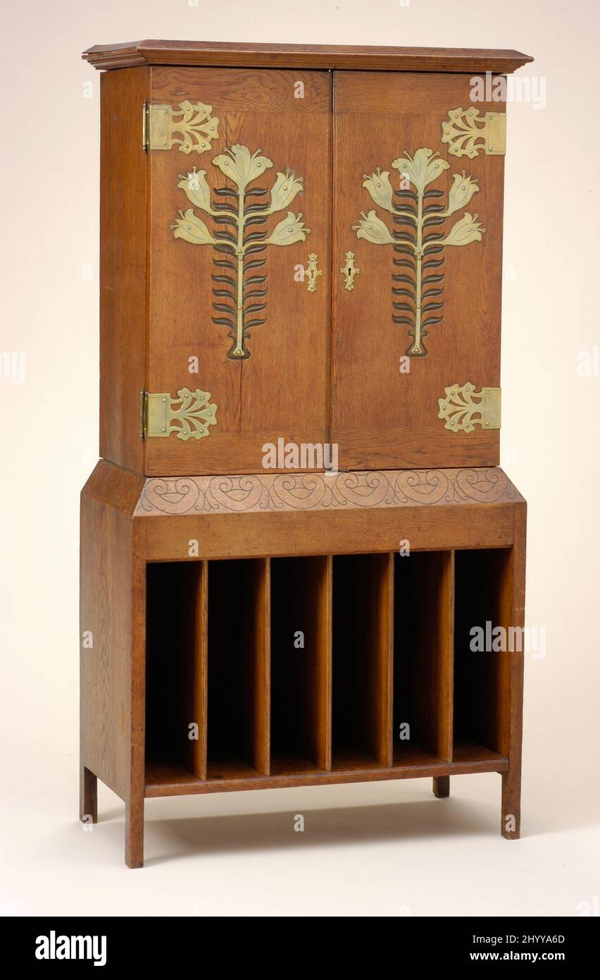 Music Cabinet after design for the New Palace, Darmstadt. Guild of Handicraft (England, London 1888-1902)Mackay Hugh Baillie Scott (England, Kent, 1865-1945). England, circa 1898. Furnishings; Furniture. Oak, pine, and brass Stock Photo