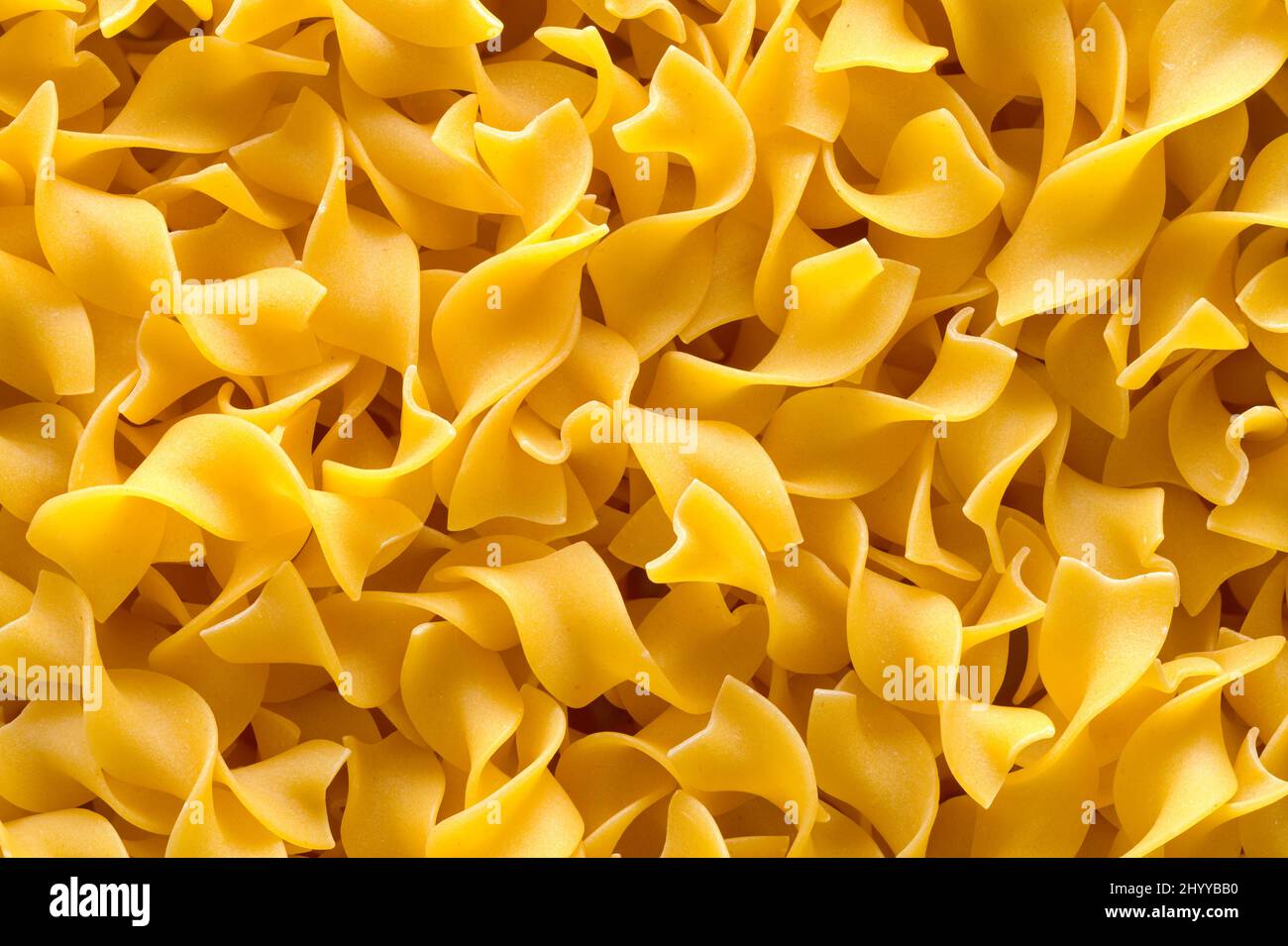 Pile of Egg Noodle Pasta Background Close Up. Stock Photo