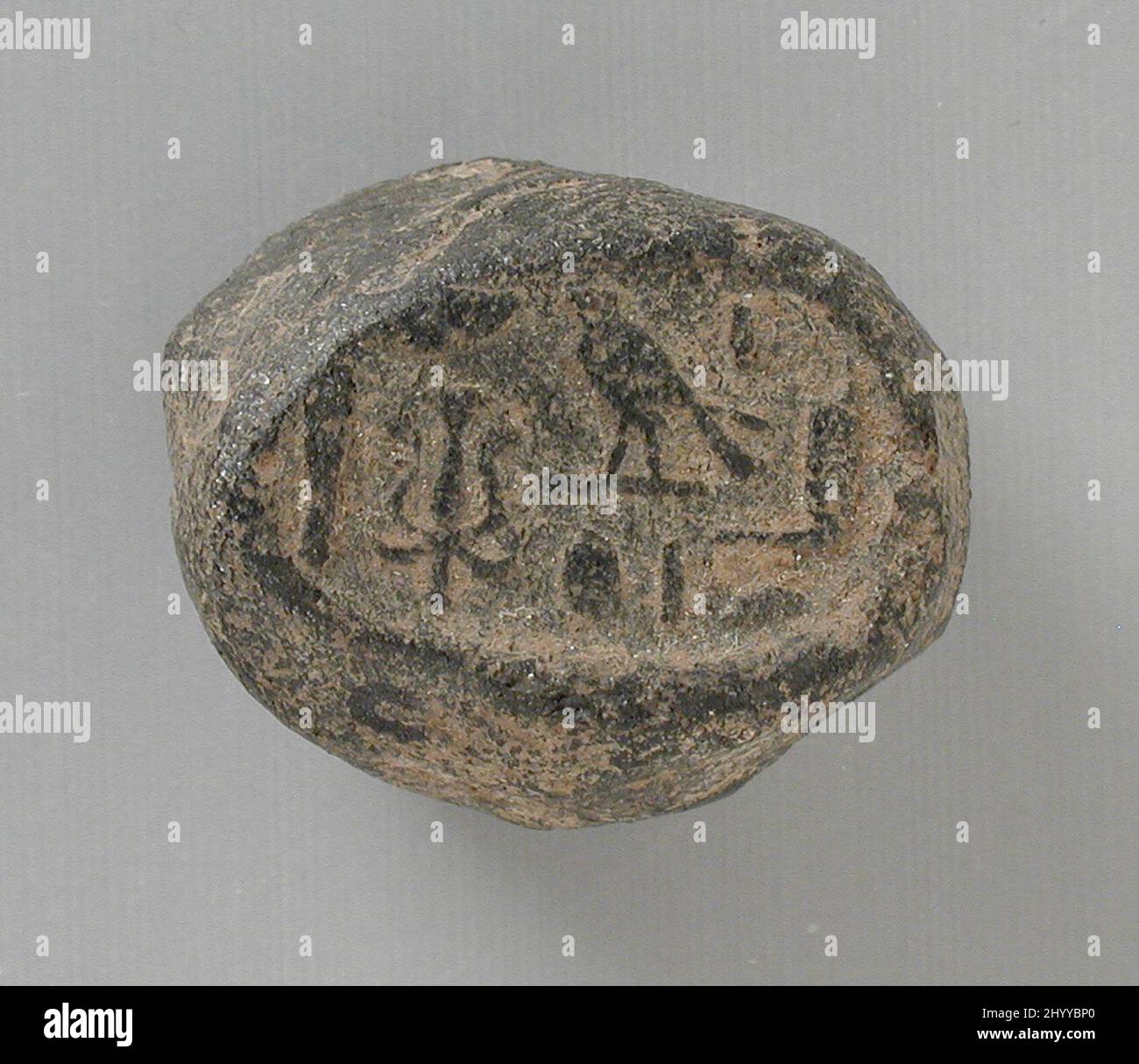 Seal Impression Mentioning Horus Son of Isis. Egypt, Late Period - Ptolemaic Period (714 - 30 BCE). Tools and Equipment; seals. Gray semi-baked clay Stock Photo