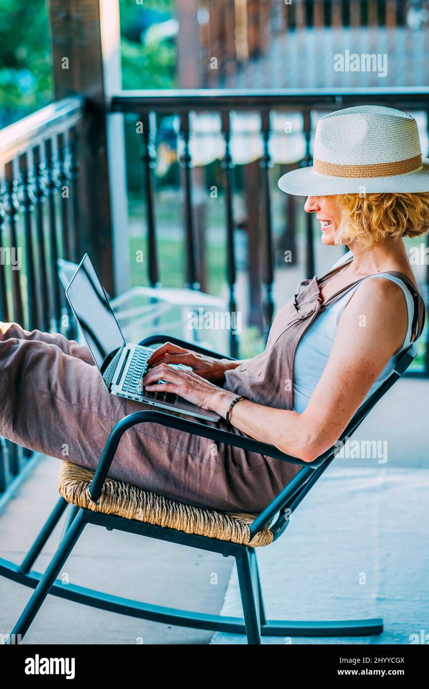 Mature woman computer home alone hi-res stock photography and images ...
