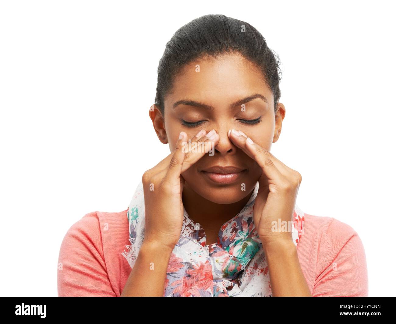 Sinus pain... not again. A pretty young woman battling sinus problems while isolated on a white background. Stock Photo