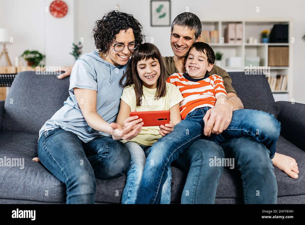 Young beautiful happy family relaxing together at home Stock Photo