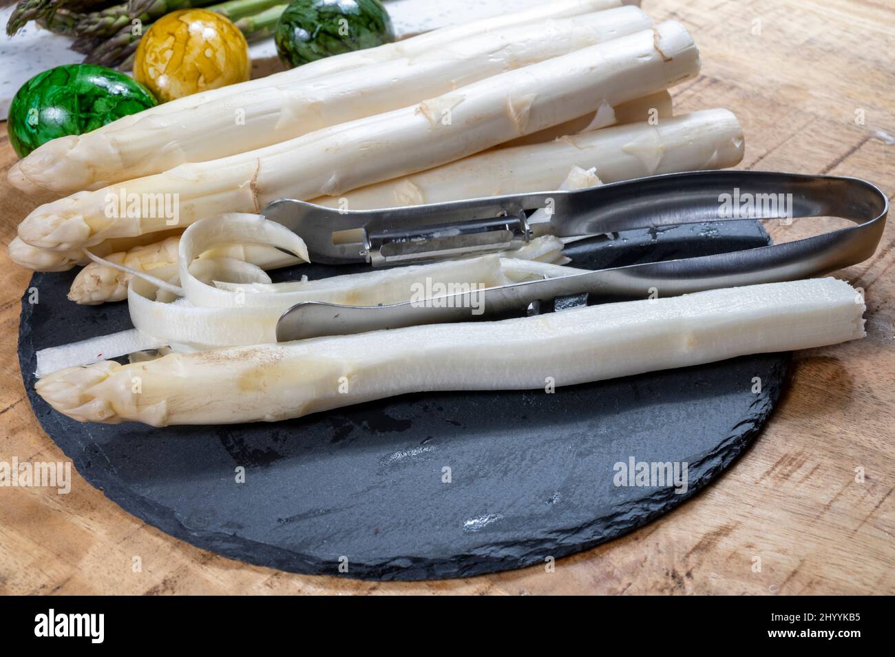 Cooking of fresh white asparagus vegetables, peeler knife for asparagus