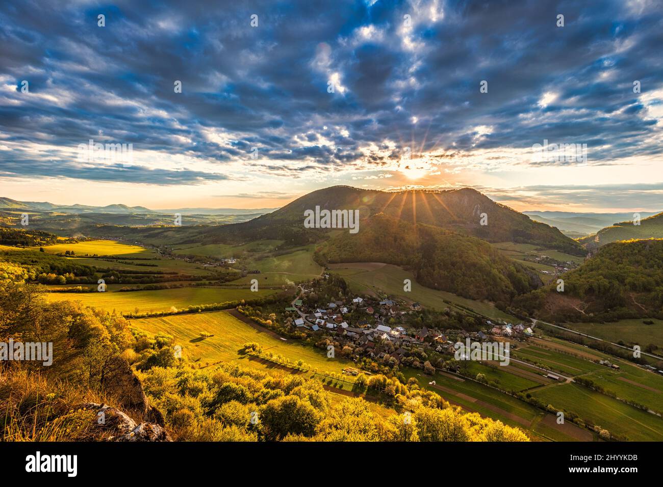 Mountainous landscape at sunset at spring time. View from the top of the Bosmany rocky hill above the Kostolec village in northwestern Slovakia, Europ Stock Photo
