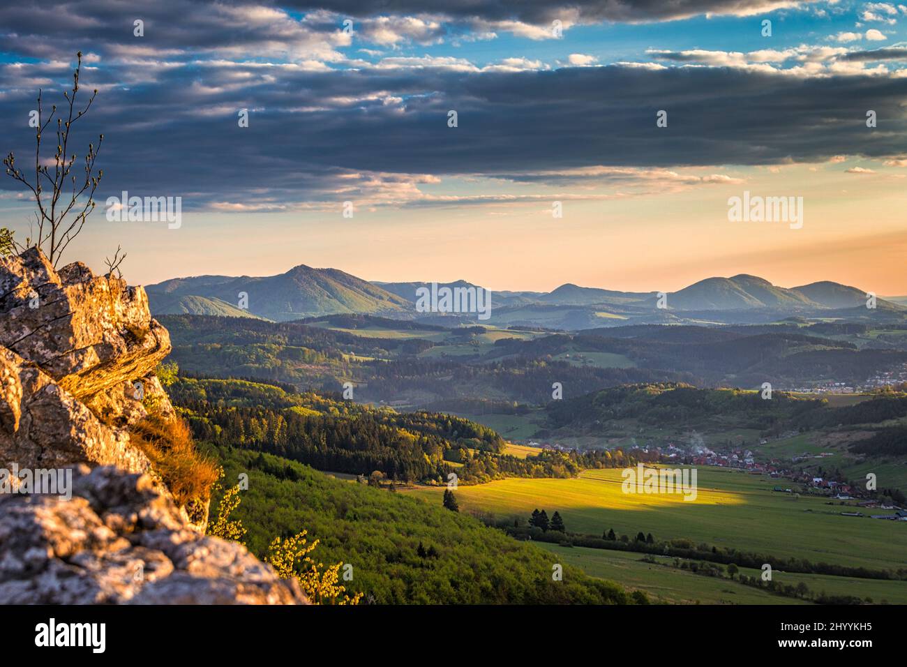Mountainous landscape at sunset at spring time. View from the top of the Bosmany rocky hill above the Kostolec village in northwestern Slovakia, Europ Stock Photo
