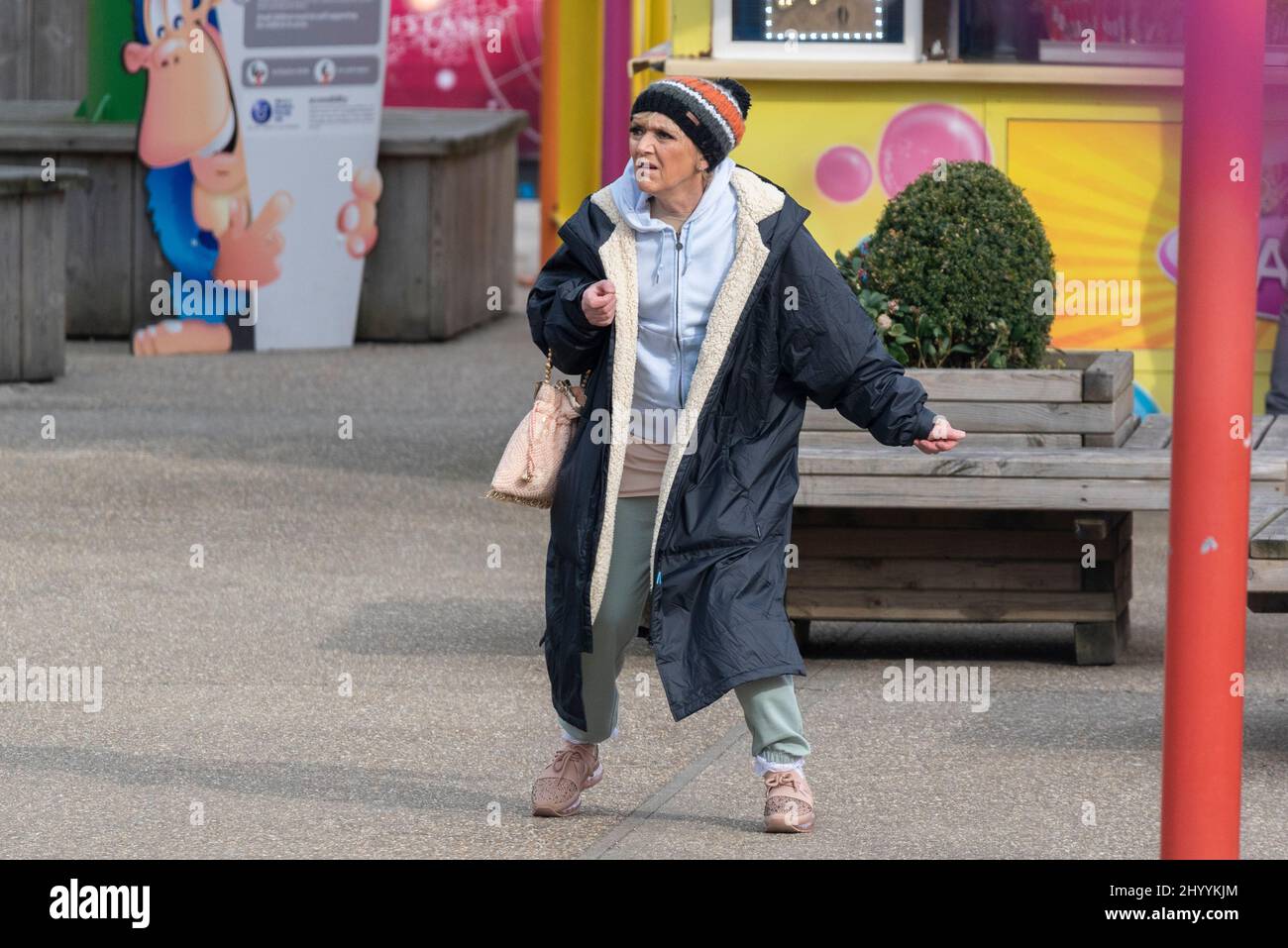 Southend on Sea, Essex, UK. 15th Mar, 2022. Filming for the BBC soap Eastenders has been taking place in the Adventure Island theme park on Southend’s seafront. The character Jean Slater, played by actor Gillian Wright, is seen running through the park seemingly in a panic. Rehearsal run through pictured in normal clothes. For the scene she wore a wedding dress. Bipolar storyline Stock Photo