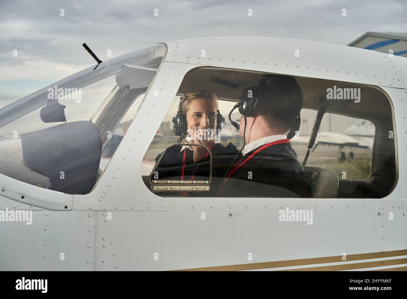 Female flight instructor giving instructions to her student on the ...