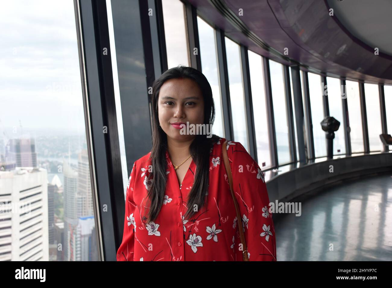 Portrait of a woman wearing a red shirt and posing for the camera near