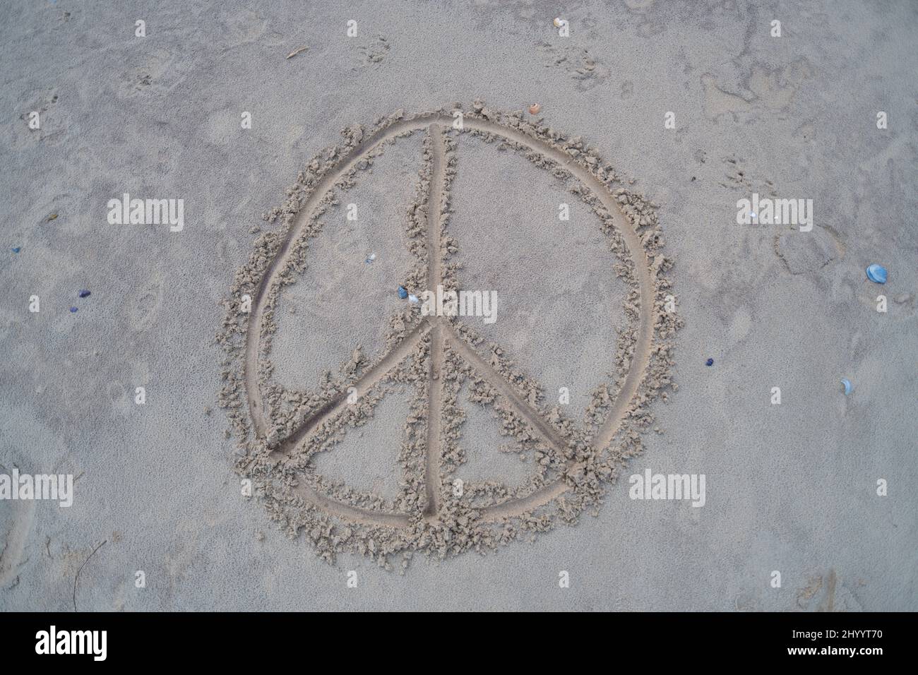 a peace sign  was drawn in the sand Stock Photo